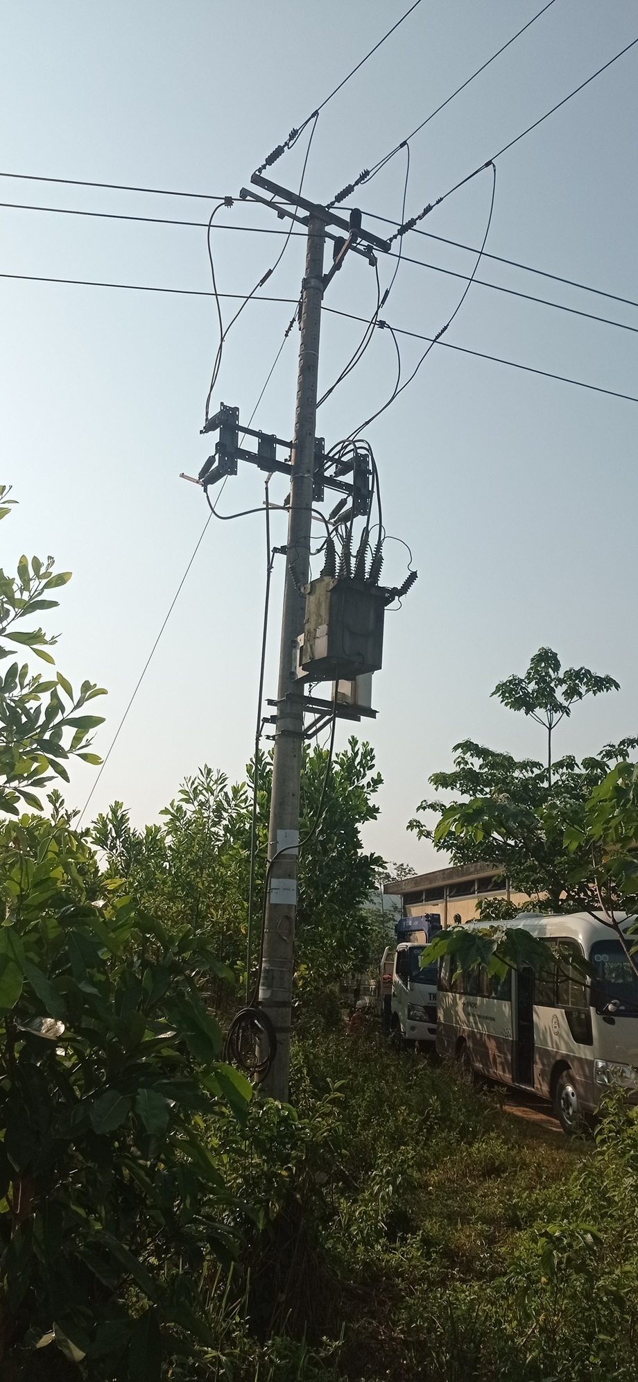 A telephone pole with wires and a box on it

Description automatically generated